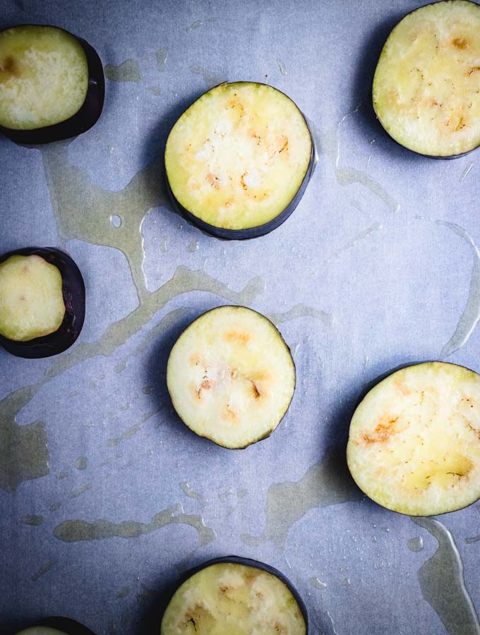 Olive oil is put onto the eggplant discs for the miso eggplant recipe.