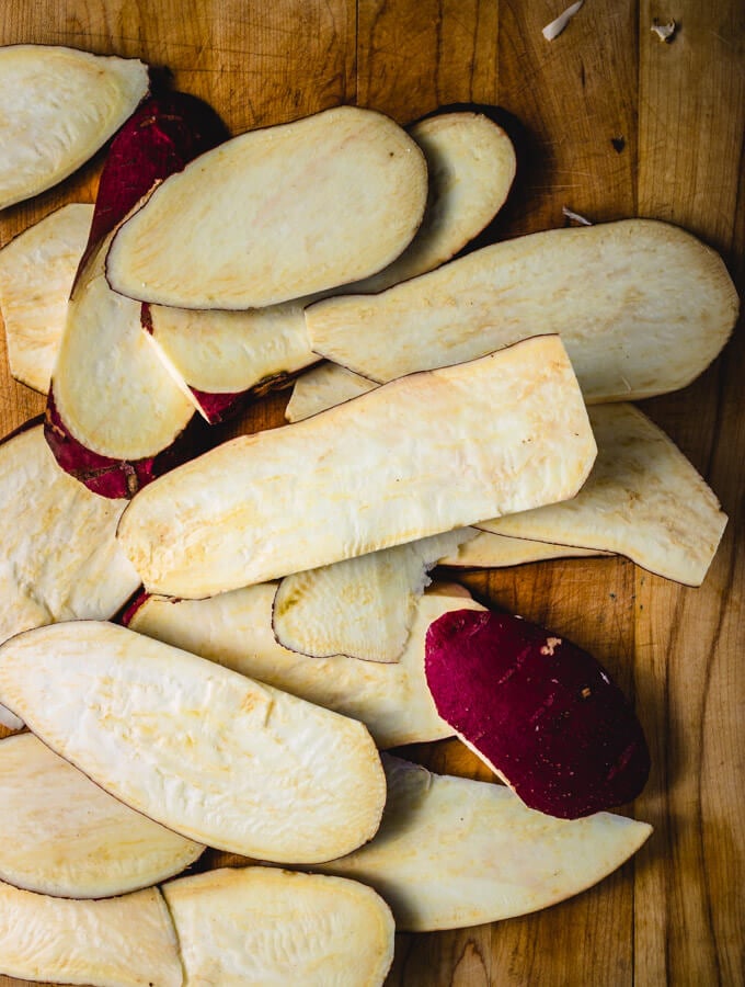 Sweet potatoes cut up length wise for the roasted miso sweet potato recipe.