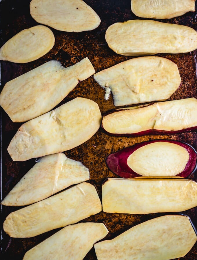 The sweet potatoes are spread out in roasting pan with olive oil so they don't stick.