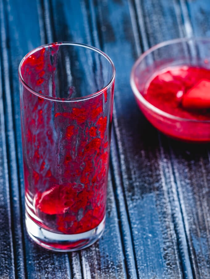 Painting the glass with the raspberry mixture.