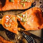 Roasted butternut squash with brown sugar cut open in pan.