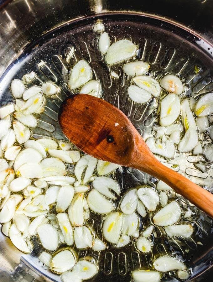 Sliced garlic being sauteed for the red sauce.