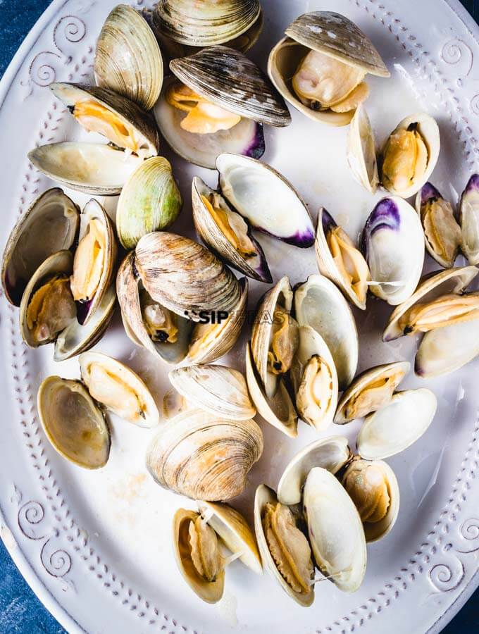 Clams In Red Sauce - sipandfeast.com #seafoodrecipe #dinner #italianfood #clams The clams opened up and plated temporarily.