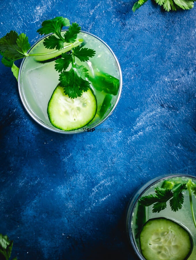 Jalapeno Margarita with Cucumber - sipandfeast.com #cocktails #margarita #drinkrecipes Flat lay shot of jalapeno margarita.