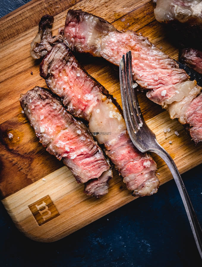Medium rare sliced ribeye steak.