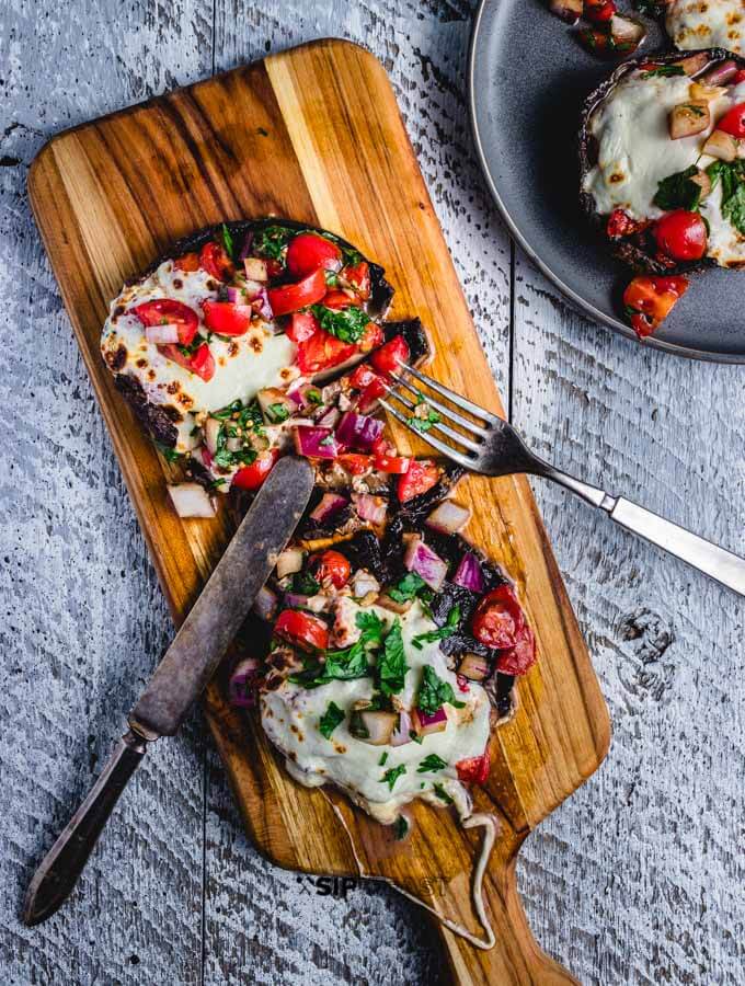 baked stuffed portobello mushrooms with the bruschetta and mozzarella final image.