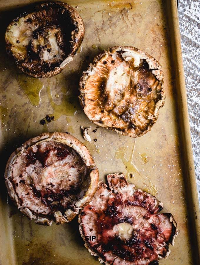 Portobello mushrooms on baking pan.