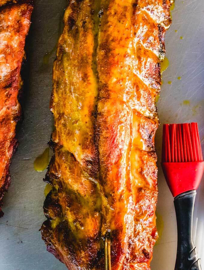 Colman's Mustard Ribs are removed from smoker and Carolina mustard bbq sauce is applied.