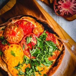 Cheeseless Pizza with heirloom tomatoes and basil featured image.