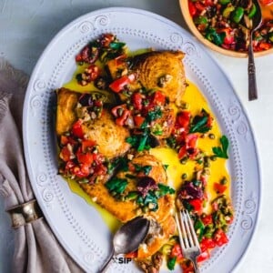 Pan seared swordfish steaks with olives and capers featured recipe card image.
