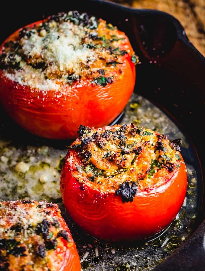 Stuffed tomatoes with ricotta salata in cast iron pan.