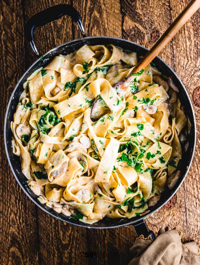 Creamy garlic mushroom pasta finished in pan.