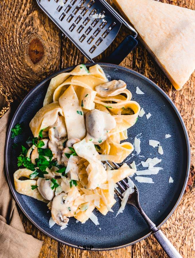 Creamy garlic mushroom pasta plated overhead shot.