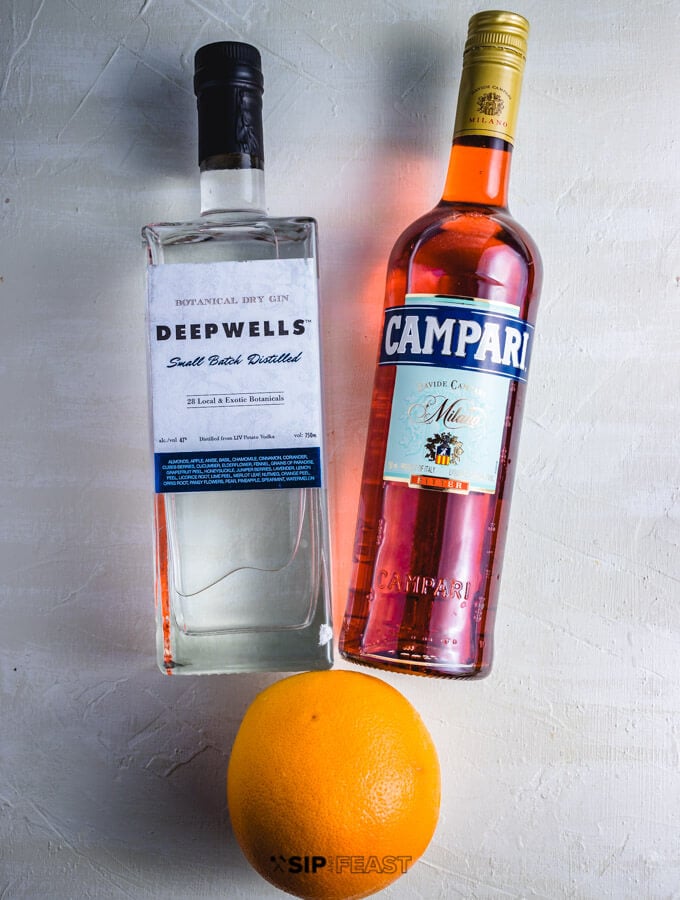 Bottle of gin, Campari and a grapefruit