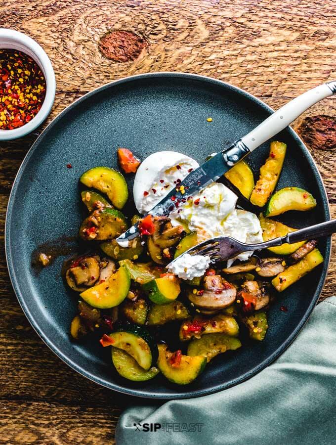 Zucchini and mushroom with burrata plated overhead shot.