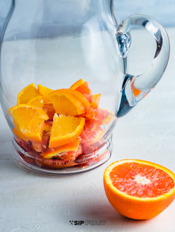 Pitcher with sliced oranges.