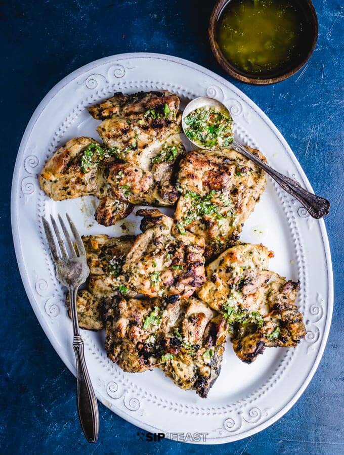 Grilled chicken thighs with Italian dressing plated overhead shot.