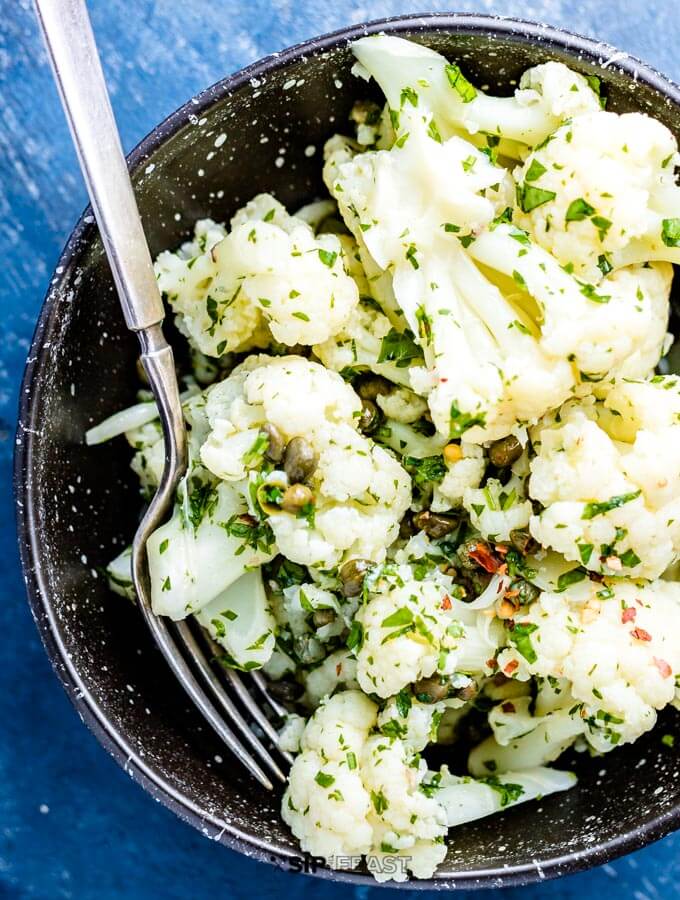 Cauliflower salad in a bowl with fork.