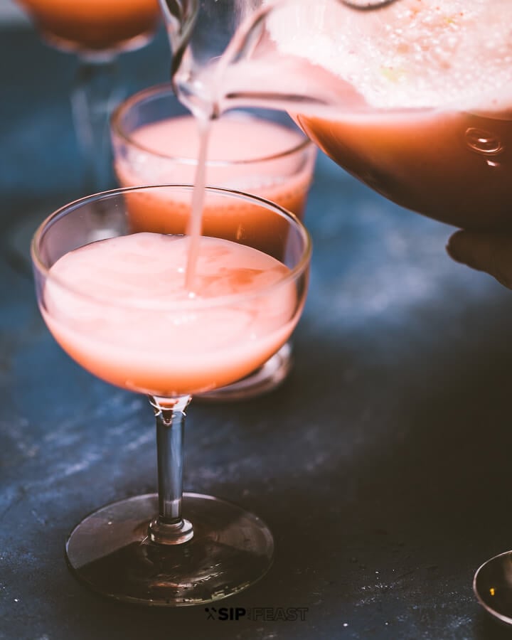 Pouring the cocktail into glasses.