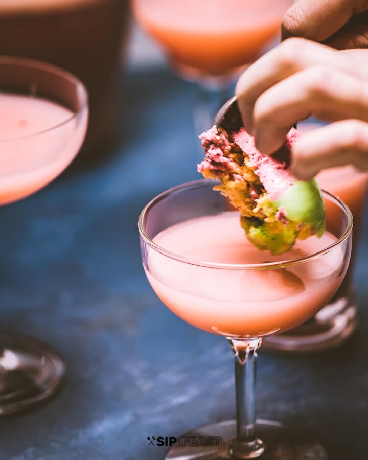 Scooping and placing sherbet in glasses.