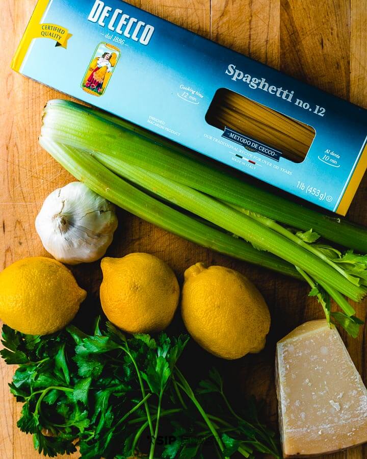 Ingredients shown: pasta, celery, garlic, lemons, parmigiano reggiano and parsley.