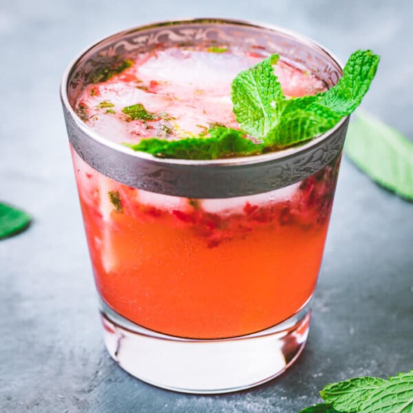 Strawberry mojito featured image in a glass on blue table.