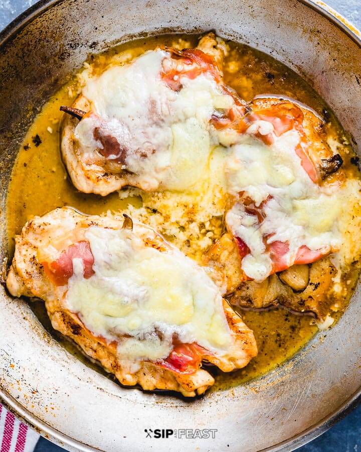 Cutlets in pan with melted fontina cheese.