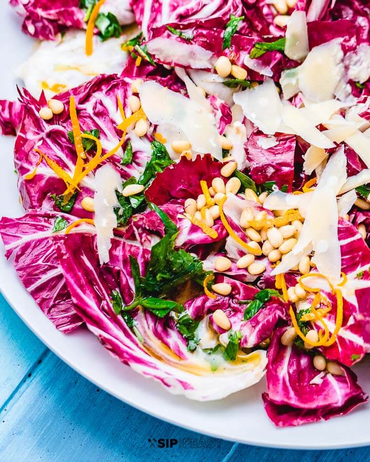 Radicchio salad close up shot in white plate on blue table.