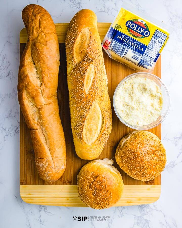 Ingredients shown: 2 loafs Italian bread, 2 seeded rolls, block of mozzarella and parmesan cheese.