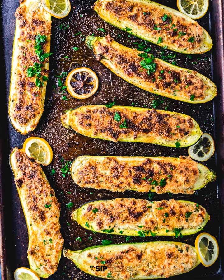 Overhead shot of stuffed zucchini boats in sheet pan.