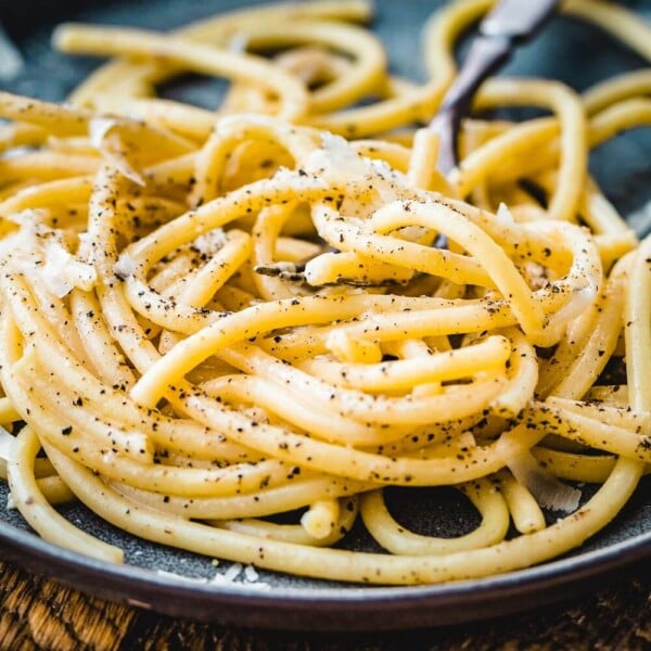 Bucatini cacio e pepe in plate with fork.