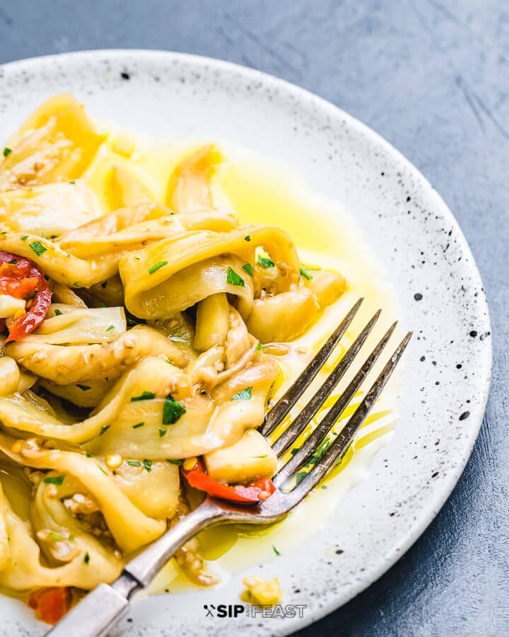 White dish with pickled Italian eggplant.