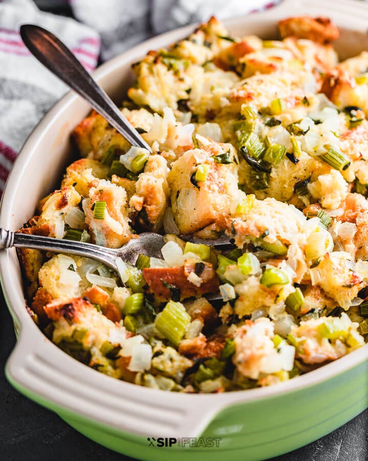 Sage and onion stuffing in green baking dish.