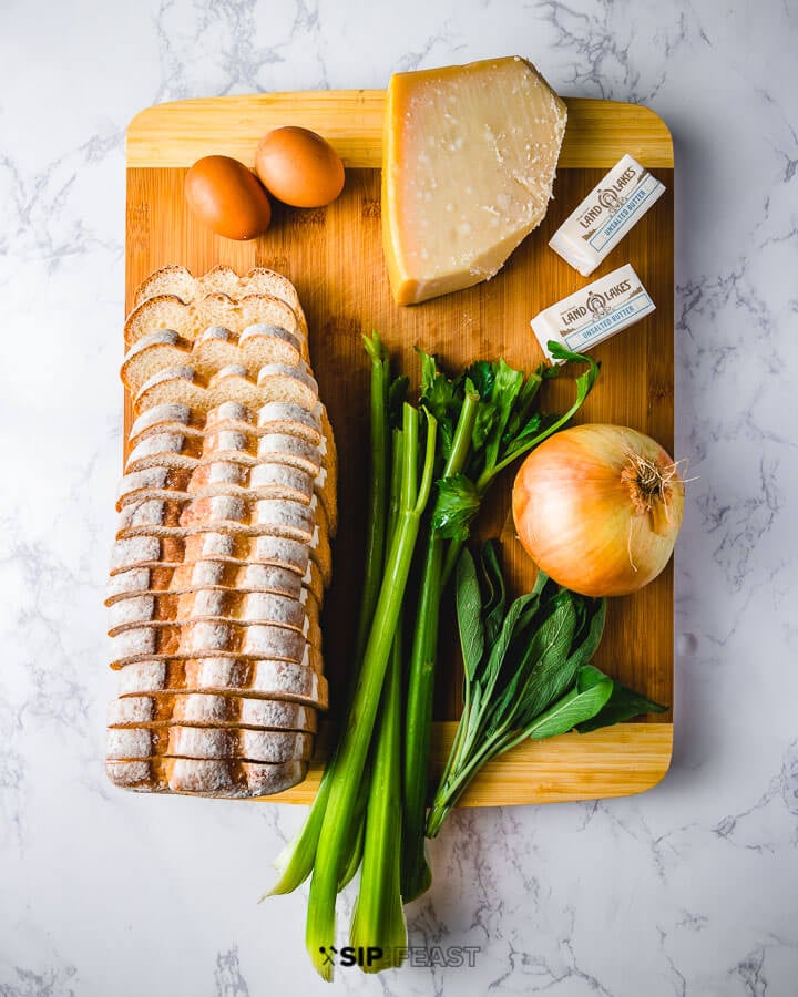 Ingredients shown on cutting board: eggs, parmesan cheese, butter, white bread, celery, sage, and onion.