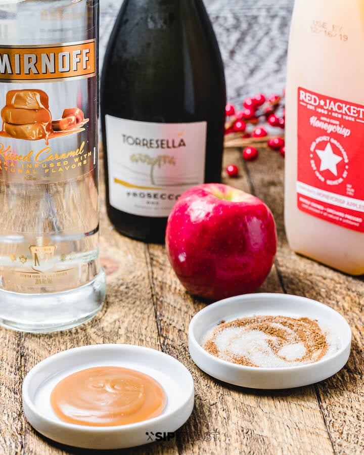 Ingredients shown: prosecco, caramel vodka, apple cider, caramel sauce, cinnamon/sugar and apple.