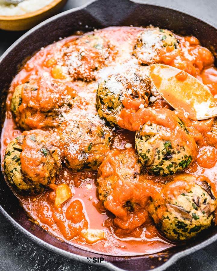 Mushroom meatballs and sauce in cast iron pan.