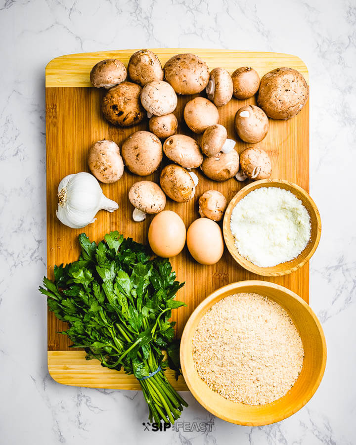 Ingredients shown: baby Bella mushrooms, garlic, Pecorino Romano cheese, parsley, and breadcrumbs.