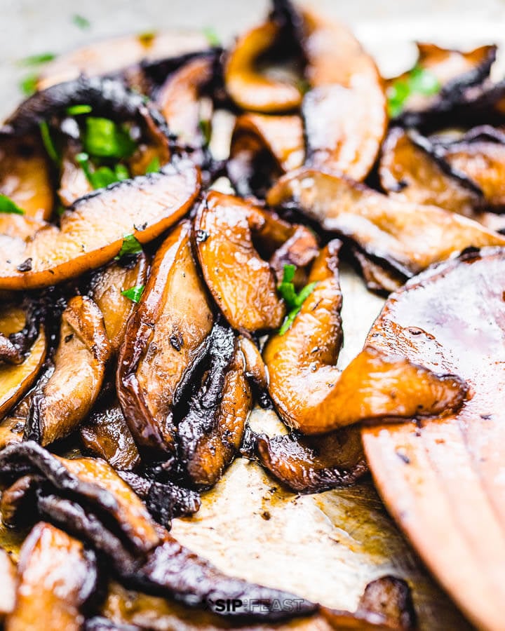 Sliced portobello mushrooms in pan.