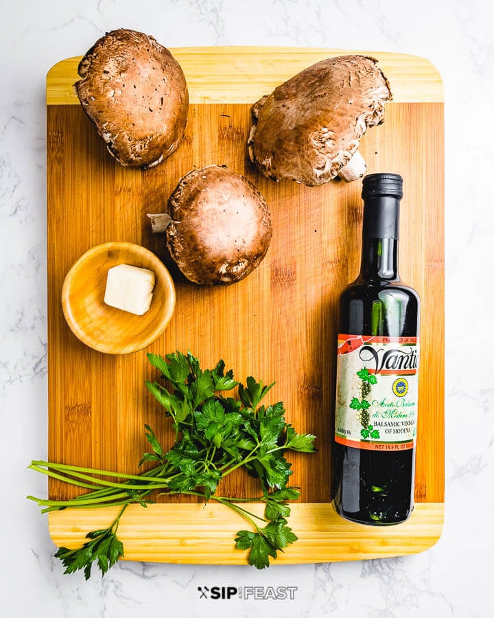 Ingredients shown on cutting board: portobello mushrooms, butter, parsley, and balsamic vinegar.