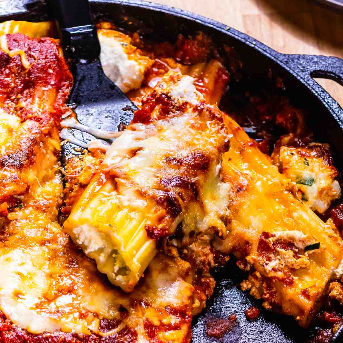 Creamy Four Cheese Baked Manicotti - Sip and Feast