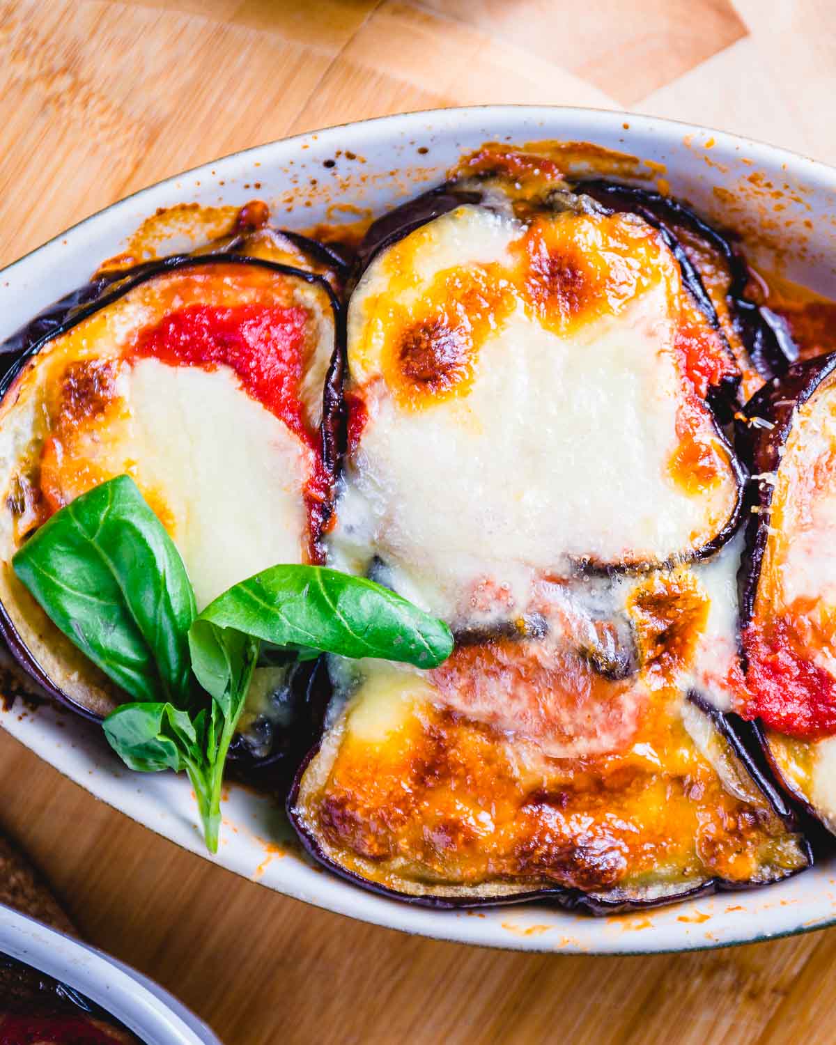 Eggplant parmigiana in small oval shaped bowl.