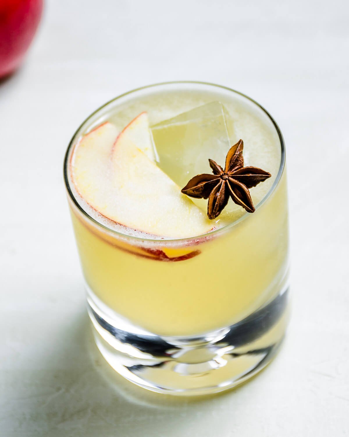 Apple margarita in glass with star anise garnish.