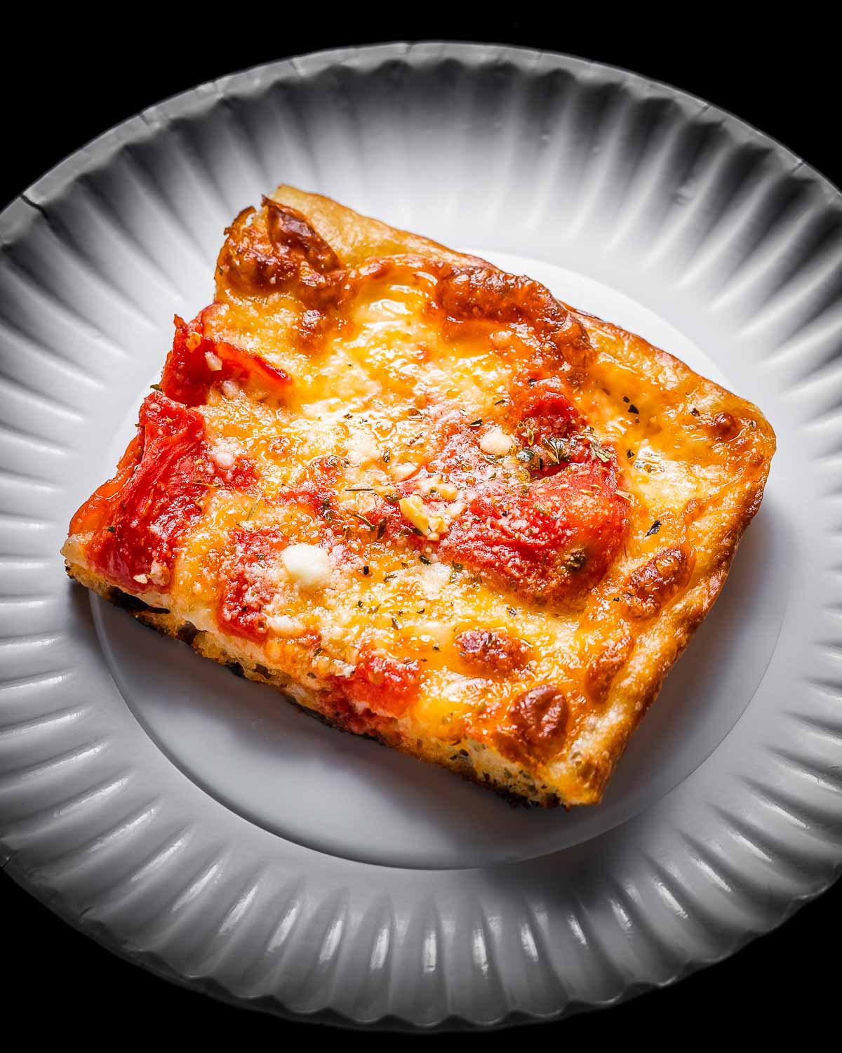 Grandma pizza in white plate.