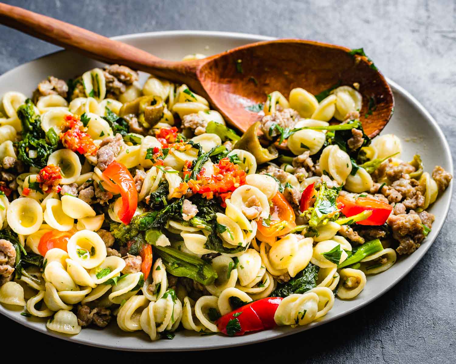 Platter of orecchiette, sausage, broccoli rabe, and cherry peppers.