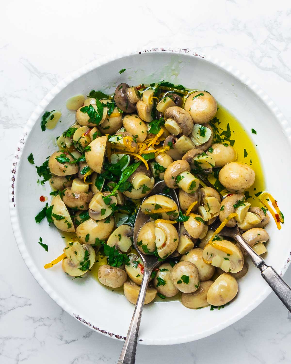 Overhead pic of plated mushrooms on marble countertop.