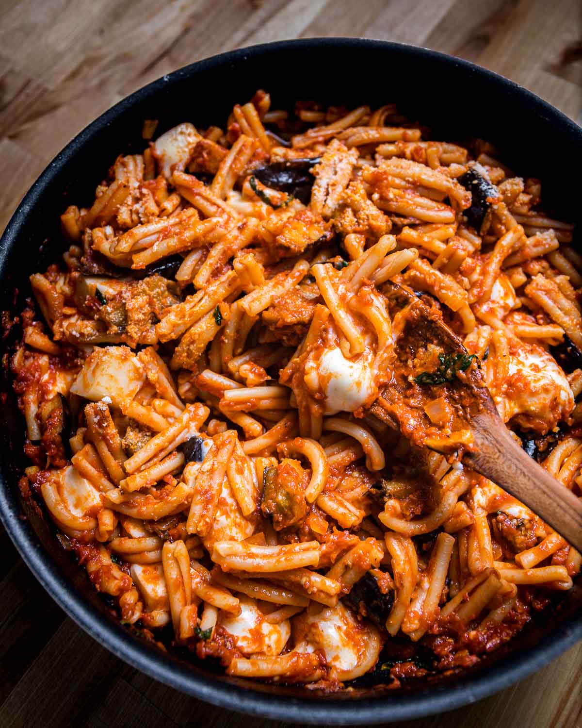 Casarecce pasta with eggplant and mozzarella in large pan.