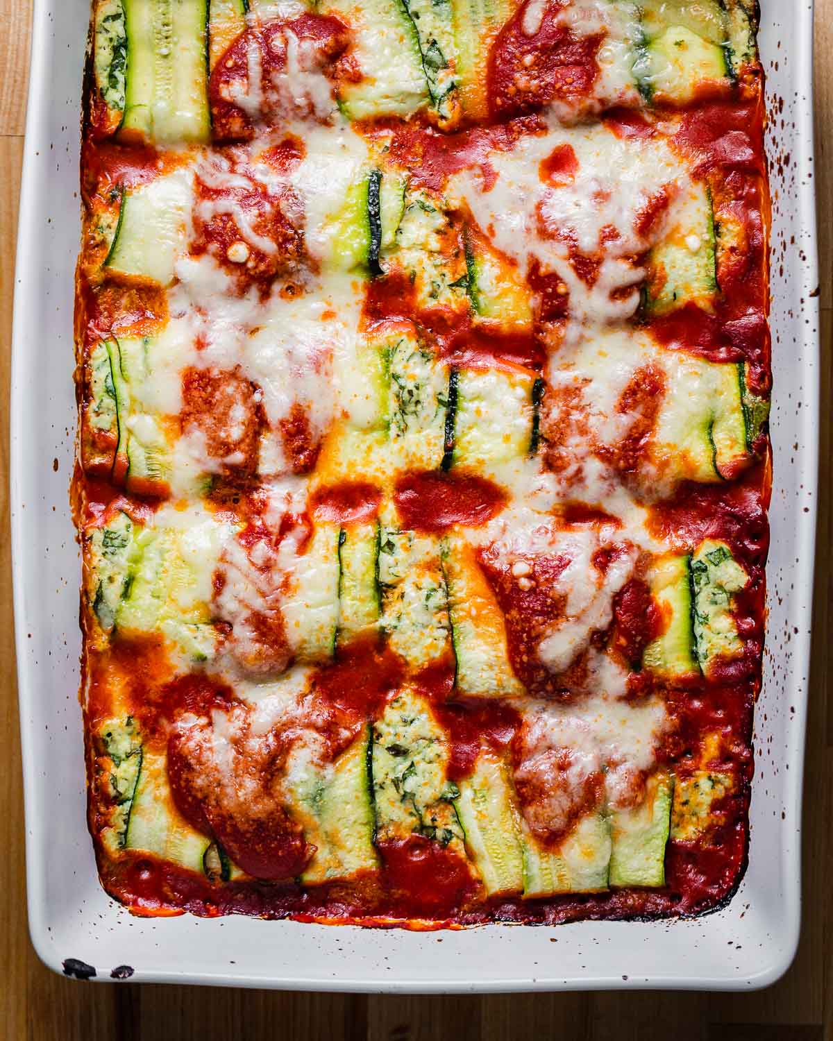 Overhead shot of large baking dish of zucchini rollatini.