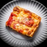 Grandma pizza slice in white plate featured image.