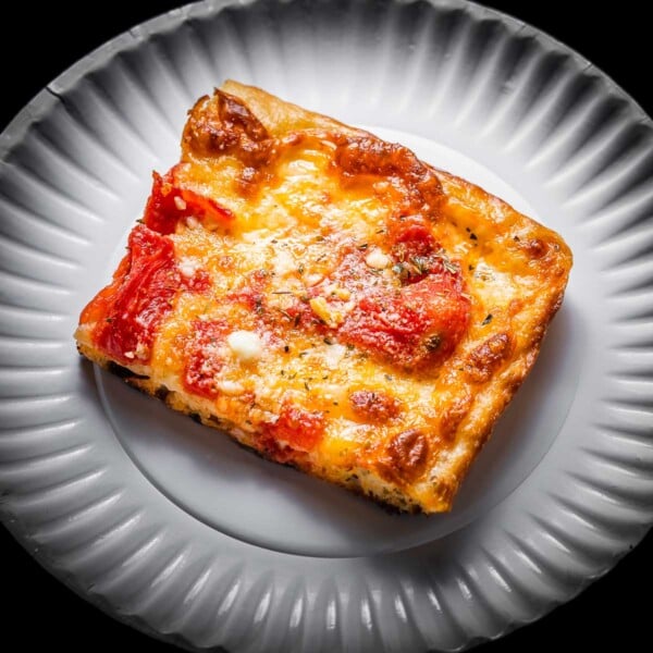 Grandma pizza slice in white plate featured image.