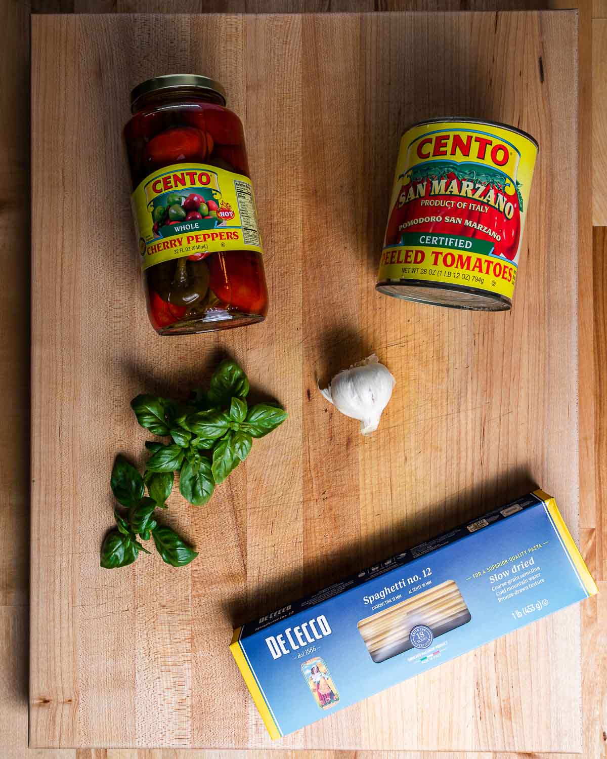 Ingredients shown: cherry peppers, San Marzano plum tomatoes, basil, garlic, spaghetti.